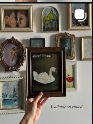 A wall hung salon-style with framed paintings